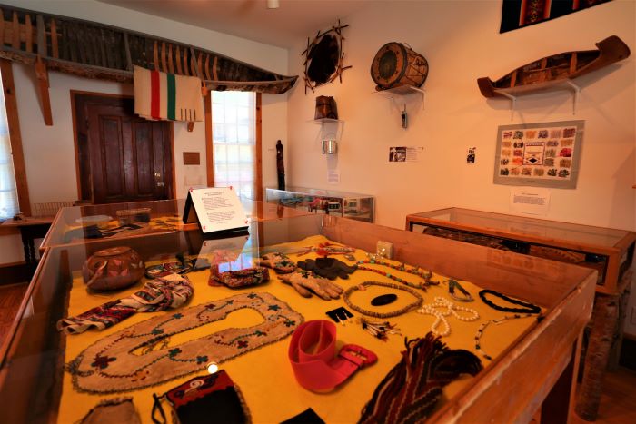 A glass case of artifacts at The Andrew Blackbird Museum.